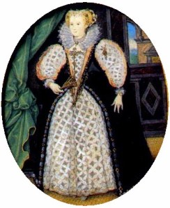 A full length portrait of a dark-eyed, fair-haired woman.